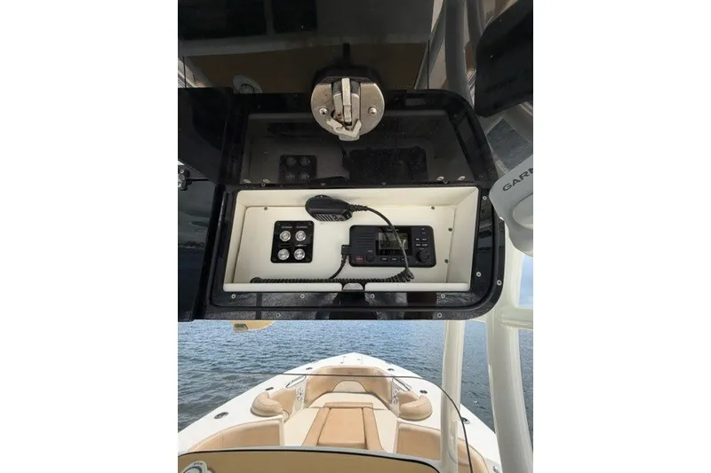 Slide: The Image of 2018 Key West 263 FS boat console with radio and controls, overlooking water. - 10