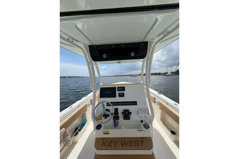Slide: The Image of 2018 Key West 263 FS boat dashboard with steering wheel and navigation equipment on open water. - 6