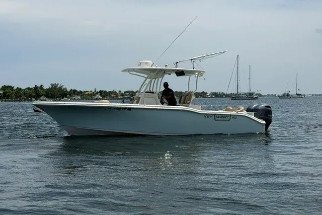 Slide: The Image of 2018 Key West 263 FS boat on calm water with distant sailboats. - 3