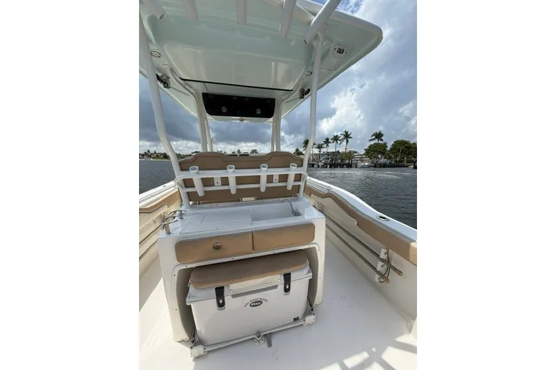 Slide: The Image of 2018 Key West 263 FS boat interior with seating and storage, on a scenic waterway. - 12