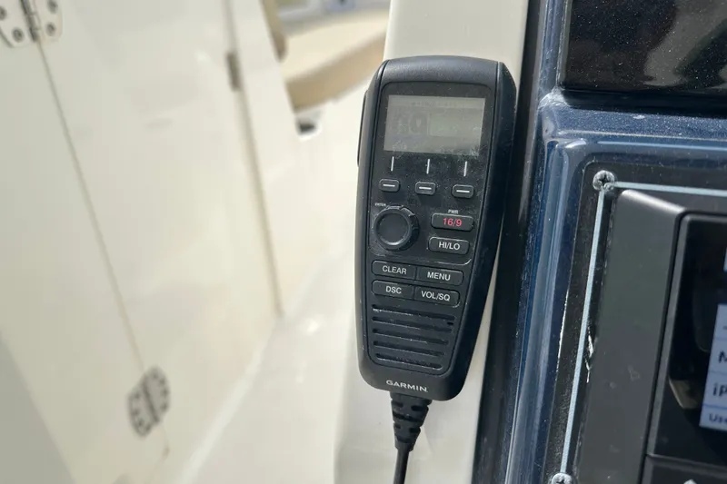 Slide: The Image of Garmin marine radio on 2021 Pursuit DC 266 Dual Console boat dashboard. - 21