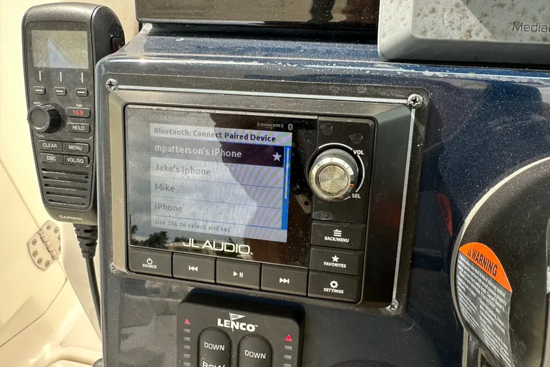 Slide: The Image of Control panel of a 2021 Pursuit DC 266 Dual Console boat with JL Audio system. - 20