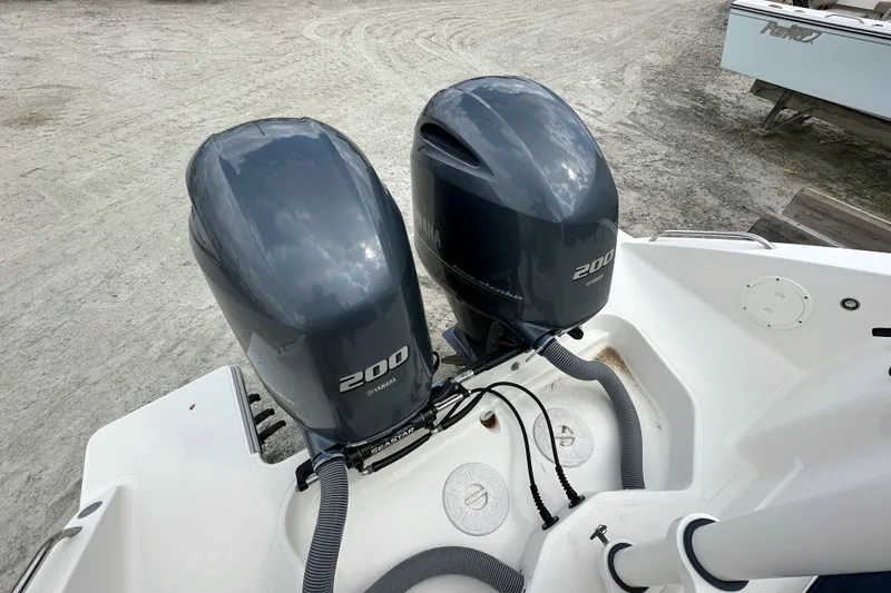 Slide: The Image of Twin Yamaha 200 engines on a 2021 Pursuit DC 266 Dual Console boat. - 13