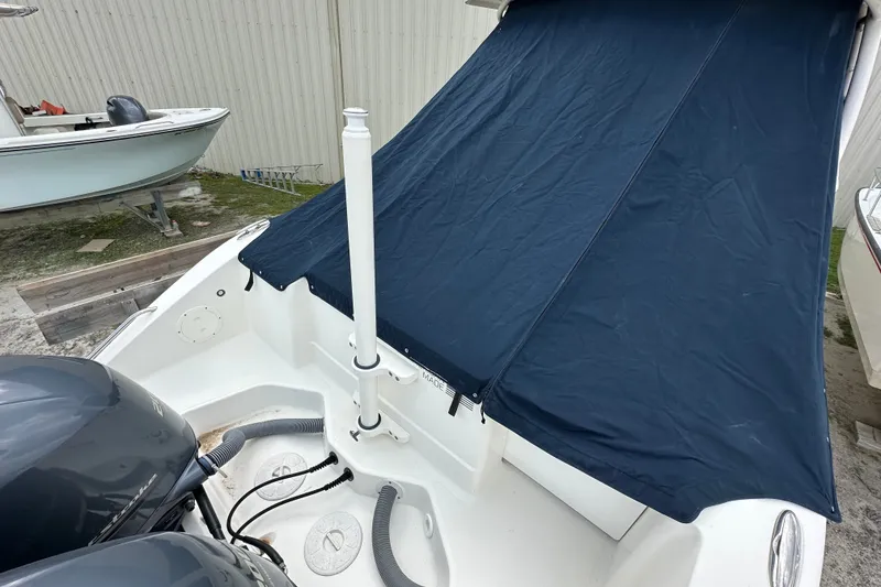 Slide: The Image of 2021 Pursuit DC 266 Dual Console boat with blue cover and twin engines. - 15
