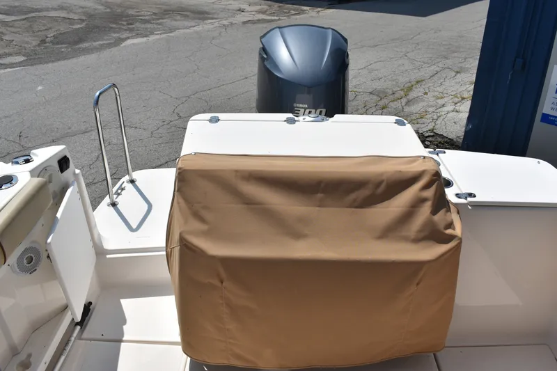 Slide: The Image of 2019 Ranger Tugs R-27 boat stern with covered seating and Yamaha outboard motor. - 13