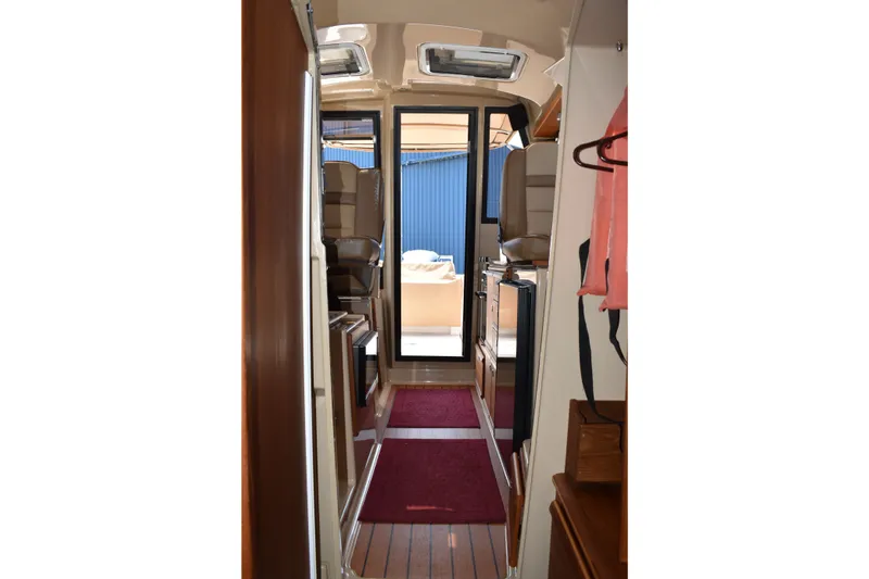 Slide: The Image of Interior view of 2019 Ranger Tugs R-27 boat, featuring a narrow hallway and seating. - 42