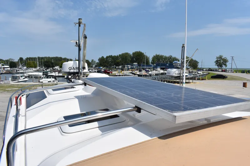 Slide: The Image of 2019 Ranger Tugs R-27 with solar panel, docked at marina under clear sky. - 46