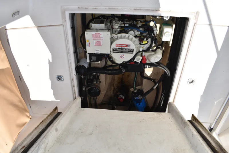 Slide: The Image of Engine compartment of a 2019 Ranger Tugs R-27 boat, featuring a Westerbeke generator. - 25