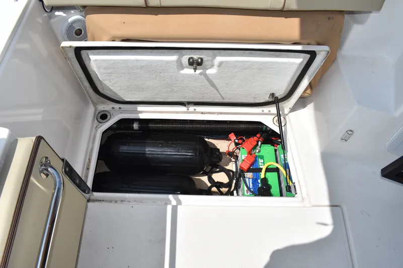 Slide: The Image of 2019 Ranger Tugs R-27 boat storage compartment with battery and equipment. - 27