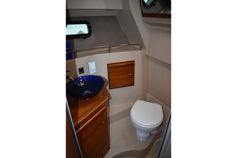 Slide: The Image of 2019 Ranger Tugs R-27 boat bathroom with modern sink and compact toilet. - 41