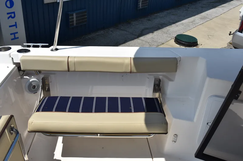 Slide: The Image of 2019 Ranger Tugs R-27 boat seat with beige and striped cushions. - 23