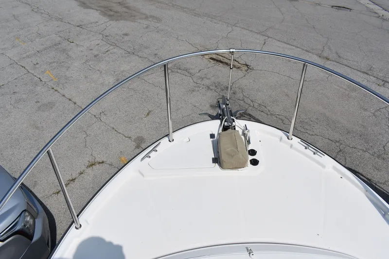 Slide: The Image of Bow view of 2019 Ranger Tugs R-27 boat on pavement, featuring anchor and railing. - 47