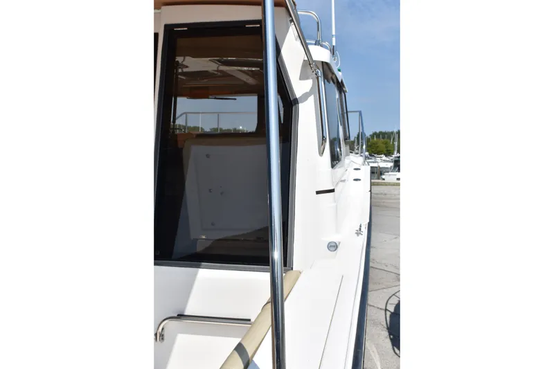 Slide: The Image of 2019 Ranger Tugs R-27 boat side view at marina. - 9