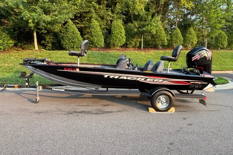 The Image of 2020 Tracker Pro Team 190 TX fishing boat on trailer, parked on a road. - 0