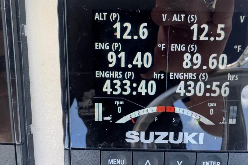 Slide: The Image of Suzuki engine display showing altitudes, temperatures, and engine hours for Contender 23 Open, 2007. - 7