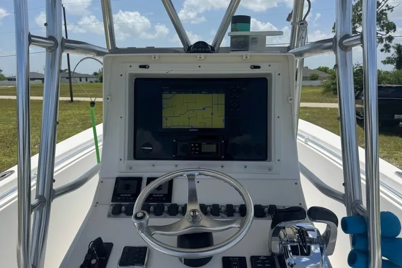 Slide: The Image of 2007 Contender 23 Open boat dashboard with navigation system and steering wheel. - 6
