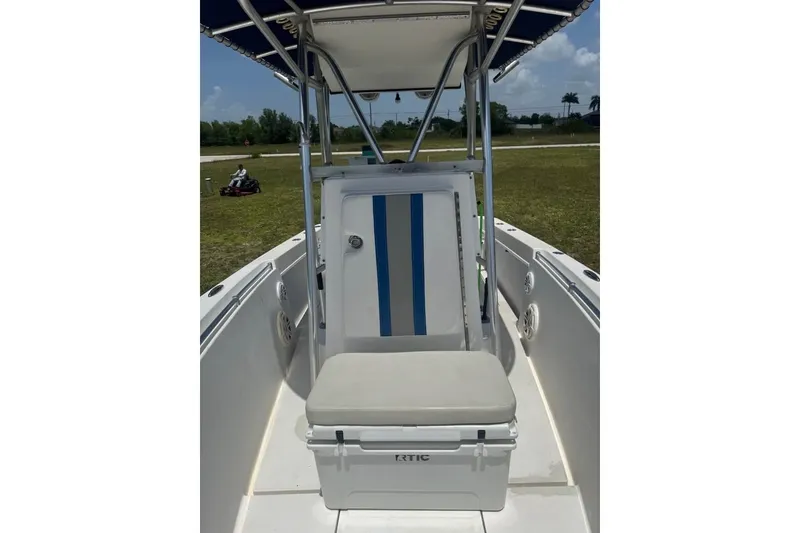 Slide: The Image of 2007 Contender 23 Open boat interior with seating and storage, outdoors on grass. - 5