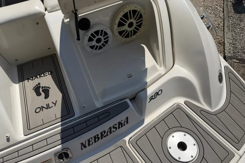 Slide: The Image of 2008 Sea Ray 290 SLX boat deck with "Naked Only" sign and speakers. - 33