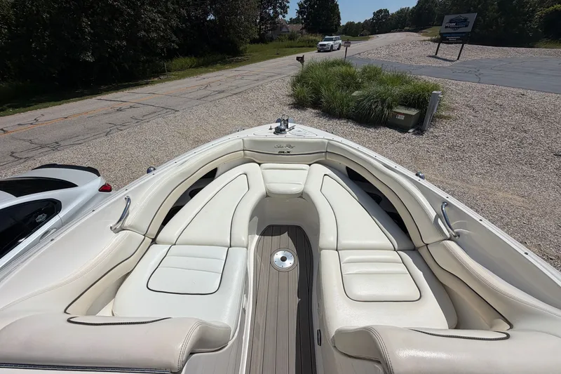 Slide: The Image of 2008 Sea Ray 290 SLX boat with spacious white seating and sleek design. - 25