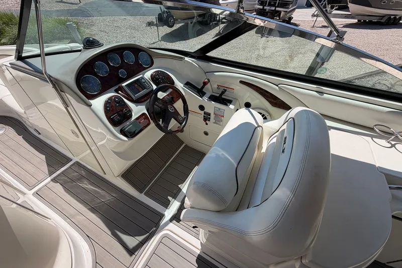Slide: The Image of 2008 Sea Ray 290 SLX boat cockpit with steering wheel and control panel. - 17