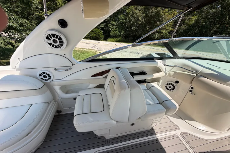 Slide: The Image of 2008 Sea Ray 290 SLX boat interior with white seating and speakers. - 16