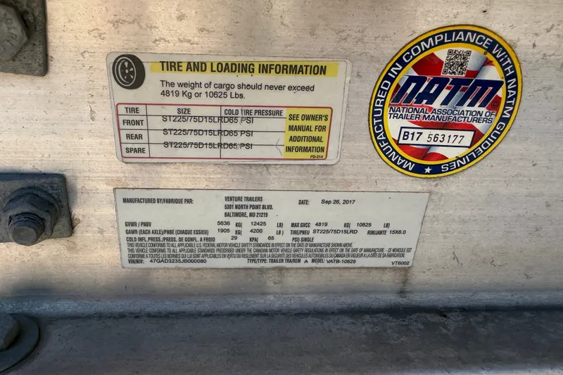 Slide: The Image of Tire and loading information label on a 2008 Sea Ray 290 SLX trailer. - 38