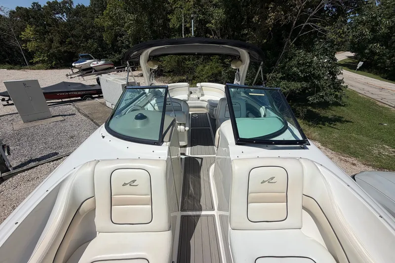 Slide: The Image of 2008 Sea Ray 290 SLX boat with open cockpit, white seating, and dual windshields. - 27