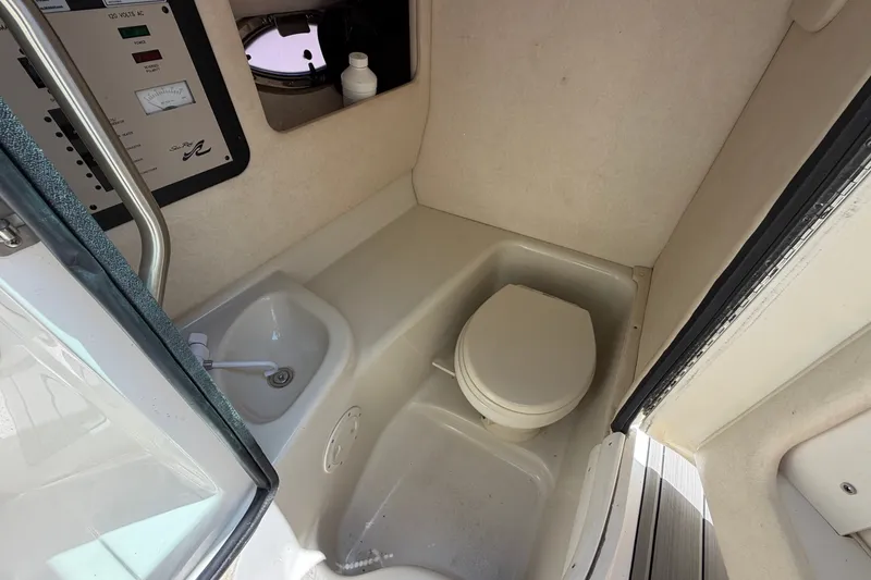 Slide: The Image of 2008 Sea Ray 290 SLX boat interior with compact bathroom and sink. - 30