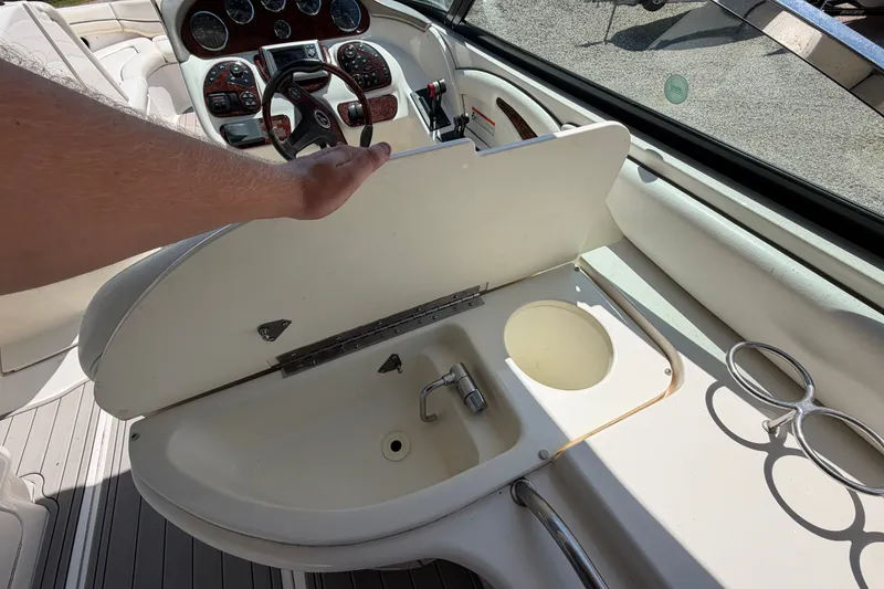Slide: The Image of 2008 Sea Ray 290 SLX boat interior with sink and steering console. - 15