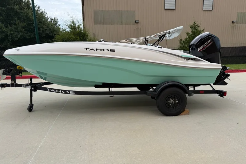 The Image of 2027 Tahoe T16 boat on trailer, mint green hull, parked outdoors. - 0