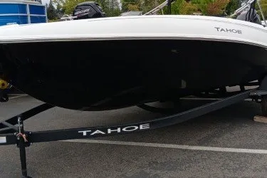 The Image of 2027 Tahoe T18 boat on trailer, showcasing sleek design and branding. - 0