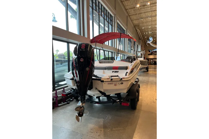 Slide: The Image of 2027 Tahoe T21 boat with outboard motor displayed indoors. - 3