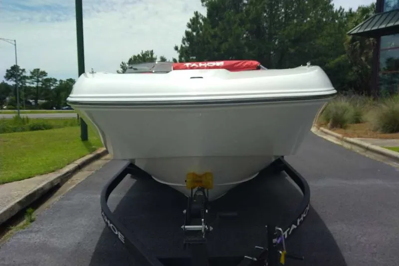Slide: The Image of 2027 Tahoe T18 boat on trailer, parked outdoors, front view. - 1