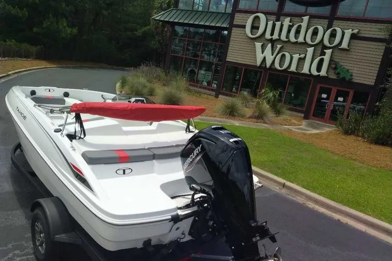 Slide: The Image of 2027 Tahoe T18 boat parked outside Outdoor World store. - 3