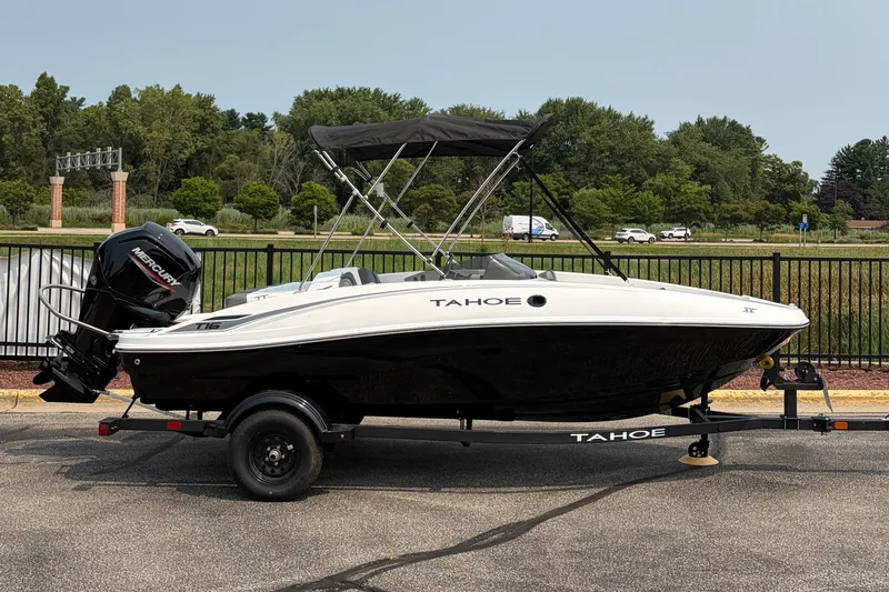 The Image of 2027 Tahoe T16 boat with Mercury engine on trailer, parked outdoors. - 0