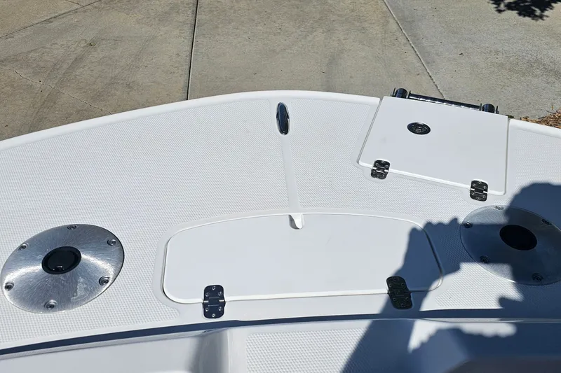 Slide: The Image of Bow of a 2027 Tahoe 1950 boat with storage compartments and metal fixtures. - 10