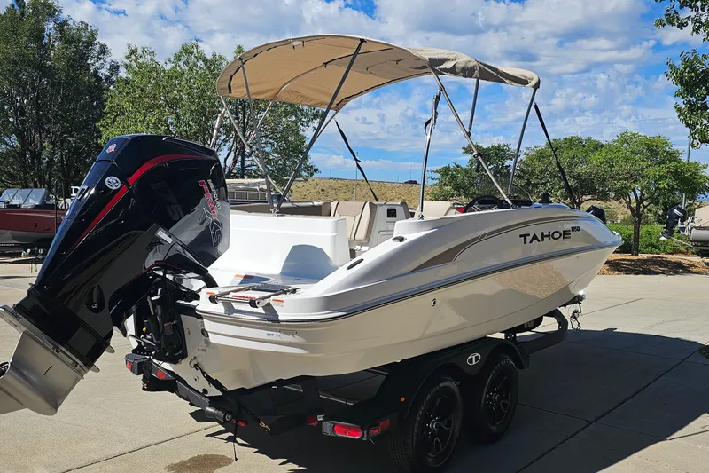 Slide: The Image of 2027 Tahoe 1950 boat with canopy and powerful outboard motor on trailer. - 5