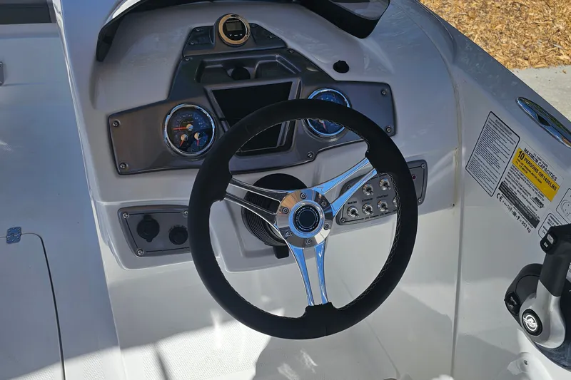 Slide: The Image of Steering console of a 2027 Tahoe 1950 boat with gauges and controls. - 12