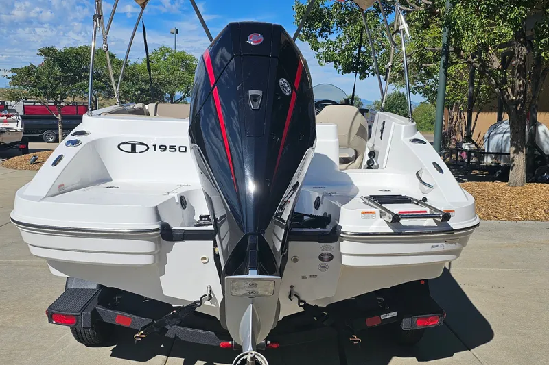 Slide: The Image of 2027 Tahoe 1950 boat with powerful outboard motor, parked outdoors. - 6