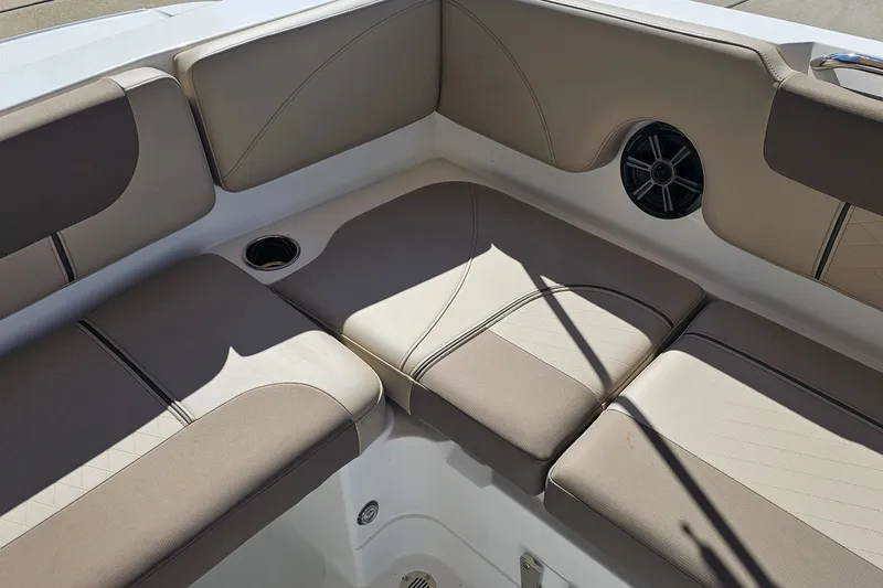 Slide: The Image of Interior seating of 2027 Tahoe 1950 boat with beige cushions and speaker. - 14