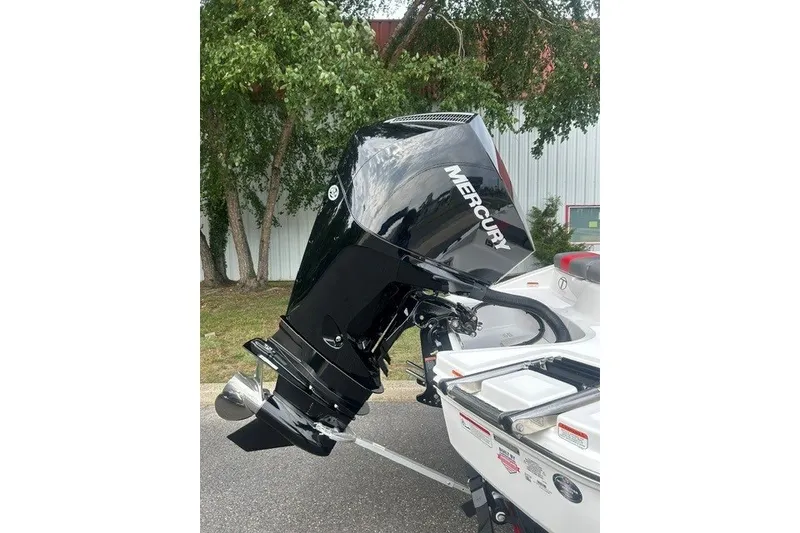 Slide: The Image of Mercury outboard motor on a 2027 Tahoe T21 boat, parked outdoors. - 4