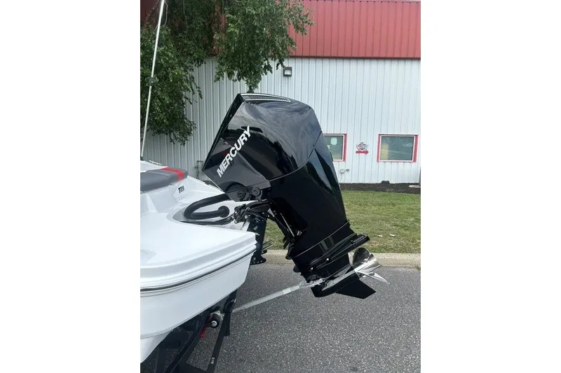 Slide: The Image of 2027 Tahoe T21 boat with Mercury outboard motor, parked near a building. - 5