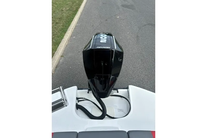 Slide: The Image of 2027 Tahoe T21 boat with Mercury 800 engine, parked on pavement. - 9