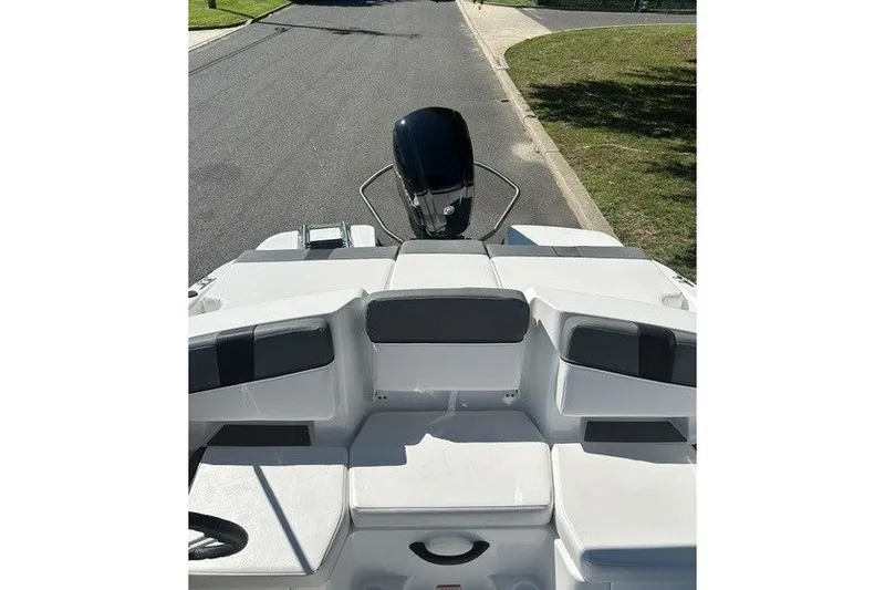 Slide: The Image of 2027 Tahoe T18 boat interior with seating and outboard motor on a sunny day. - 8