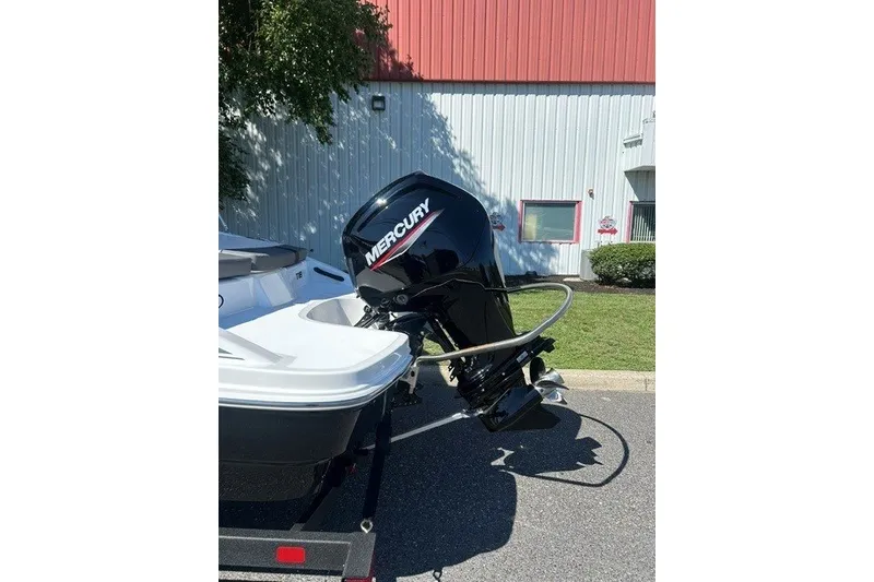 Slide: The Image of 2027 Tahoe T18 boat with Mercury outboard motor, parked outdoors. - 3