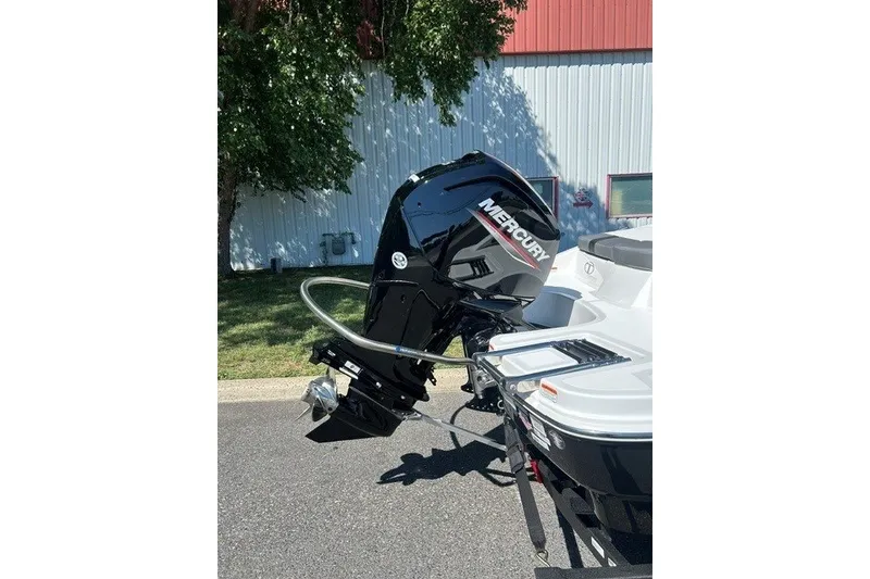 Slide: The Image of 2027 Tahoe T18 boat with Mercury outboard motor, parked outdoors. - 2