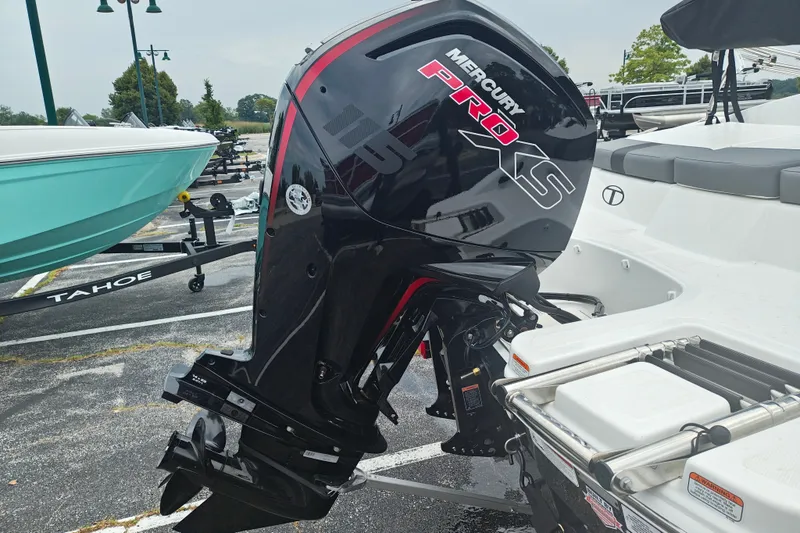 Slide: The Image of 2027 Tahoe T18 boat with Mercury Pro XS outboard motor in a parking lot. - 6