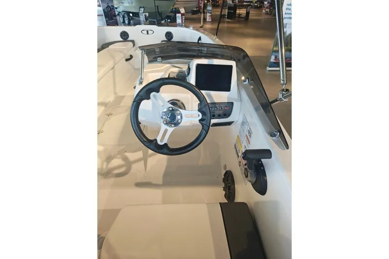 Slide: The Image of 2027 Tahoe T18 boat interior with steering wheel and dashboard controls. - 10