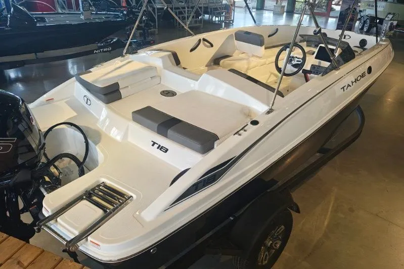 Slide: The Image of 2027 Tahoe T18 boat displayed indoors, featuring sleek white design and modern seating. - 7