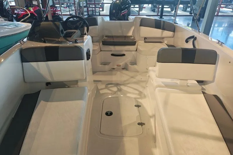 Slide: The Image of 2027 Tahoe T18 boat interior with seating and steering console in showroom. - 12